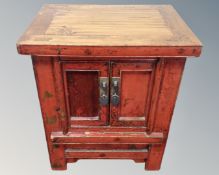 A Chinese lacquered elm double door low cabinet , 58 cm x 43 cm x 67 cm.