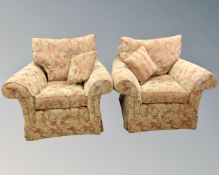 A pair of Duresta armchairs upholstered in red and golden fabric