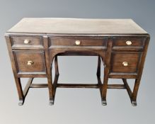 A 20th century oak five drawer knee hole dressing table (no mirror)