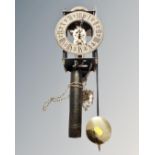 A reproduction wall clock with pendulum and weights
