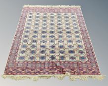 A Moroccan rug on cream ground, 190cm by 141cm.