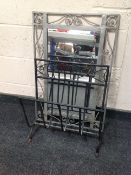 A wrought metal framed mirror together with a further iron magazine rack