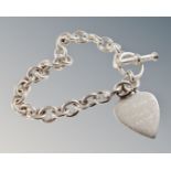 A heavy T-bar bracelet with 'Ghost' heart padlock