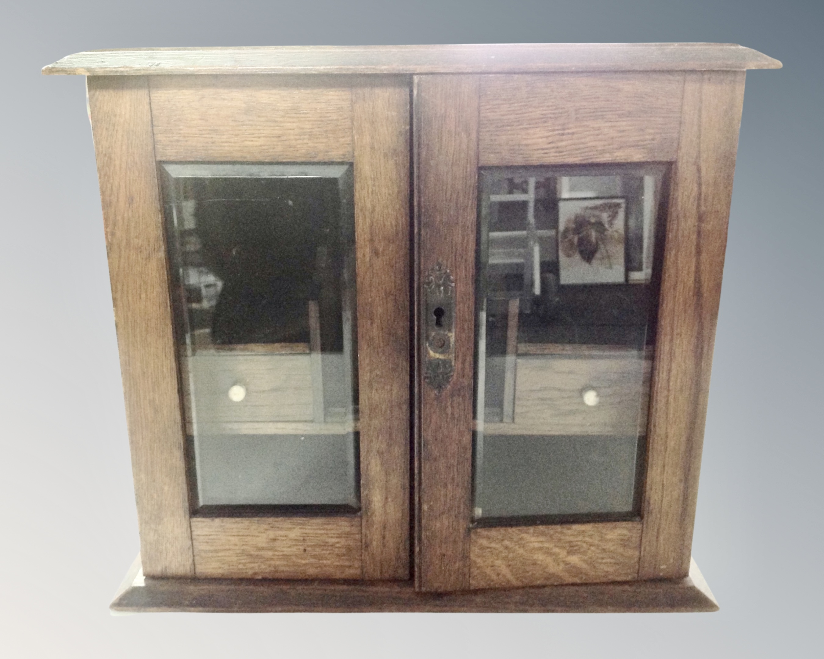 A 19th century oak smoker's cabinet.