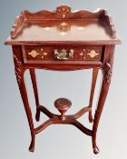 An Asian hardwood brass inlaid Regency style telephone table