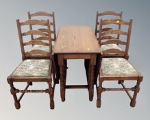 A Jaycee oak gateleg table together with a set of four ladder backed dining chairs