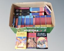 A box of hard and soft back Harry Potter volumes