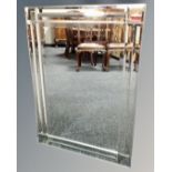 A contemporary all glass framed mirror