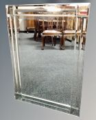 A contemporary all glass framed mirror