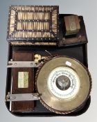 A tray of circular brass horoscope barometer, porcupine quill and ebony table box, tie press,