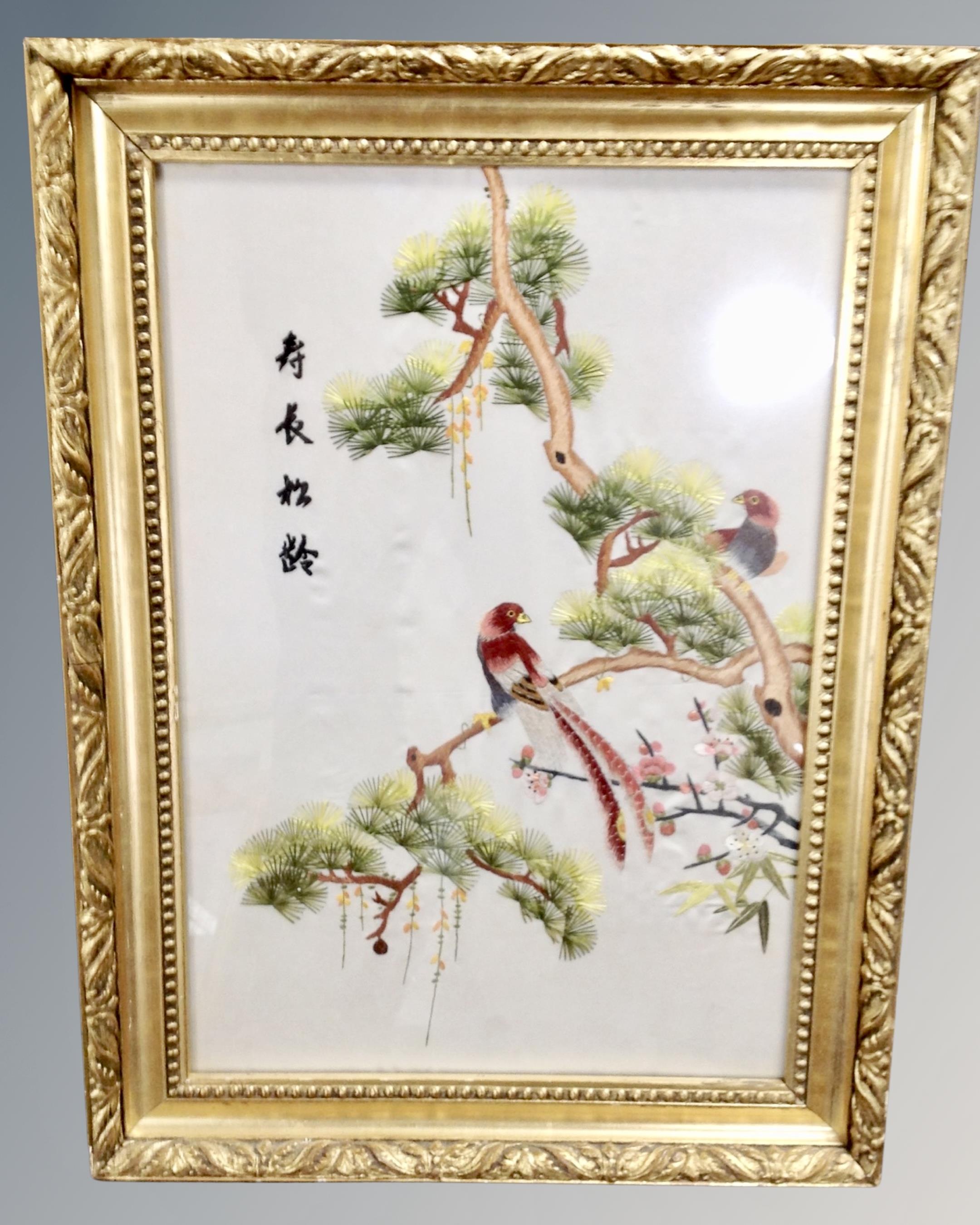 Three Chinese embroidered silk panels depicting birds, framed.