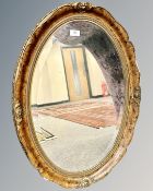 An oval gilt mirror 74 cm x 53 cm