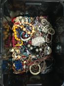 A large black storage box of costume jewellery