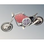 A metal contemporary wall clock in the form of a chopper bike
