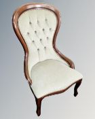 A Victorian style nursing chair in green buttoned fabric