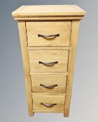 A contemporary oak narrow four drawer chest