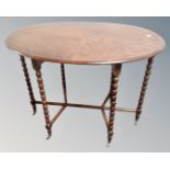 A 19th century oval inlaid occasional table on bobbin legs with brass feet
