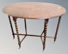 A 19th century oval inlaid occasional table on bobbin legs with brass feet