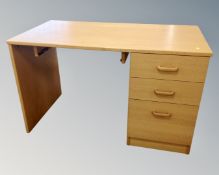 A single pedestal desk fitted with three drawers in an oak finish CONDITION REPORT:
