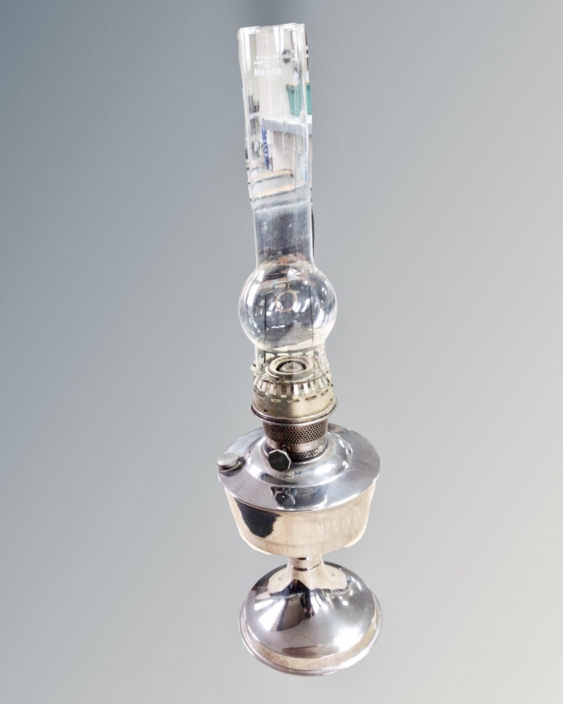 An Alladin chrome oil lamp with chimney