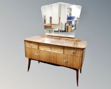 A mid 20th century teak dressing table fitted with five drawers