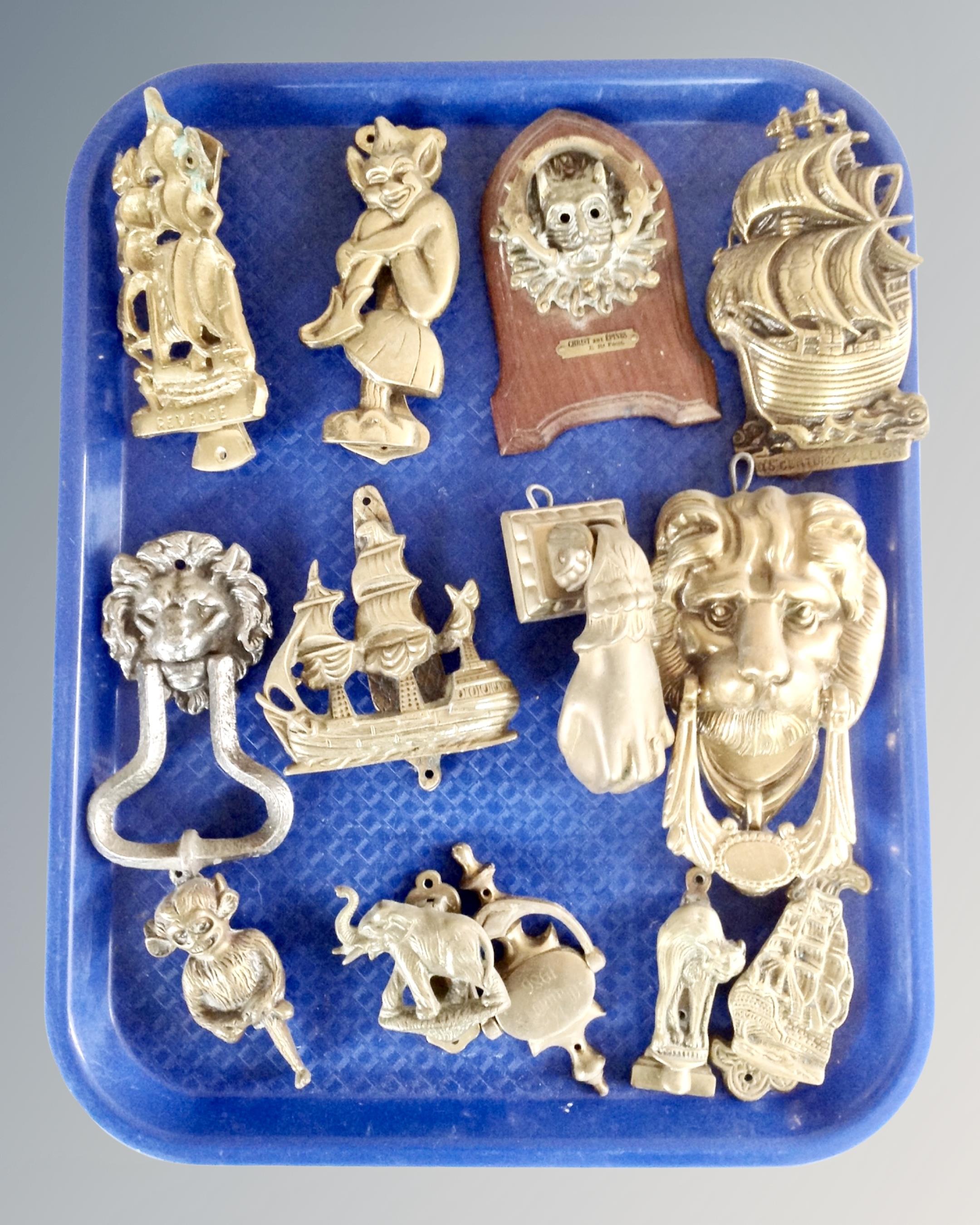 A tray of brass door knockers