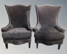 A pair of contemporary high backed armchairs in black studded fabric