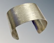 A Sterling silver cuff bangle, 58g, width 4 cm.