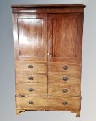 A Victorian mahogany double door hanging wardrobe with drawer beneath in the form of a linen press