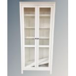 A contemporary pained pine glazed double door bookcase