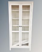 A contemporary pained pine glazed double door bookcase