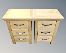 A pair of contemporary oak three drawer bedside chests