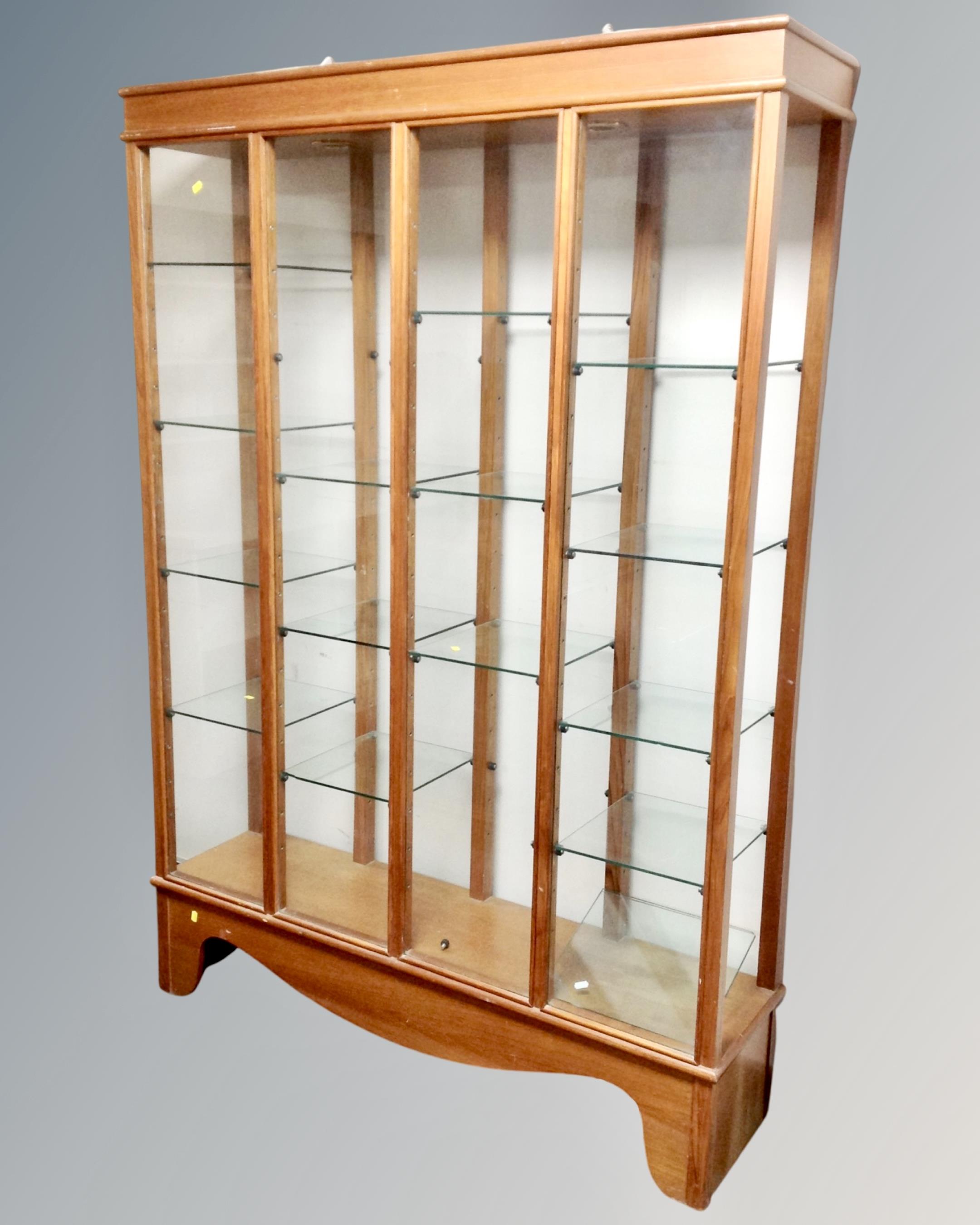 A 20th century four section glazed curio cabinet