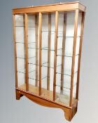 A 20th century four section glazed curio cabinet
