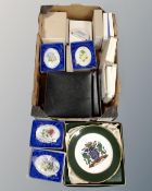 A box of plates and wall plaques,