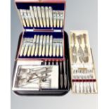 A tray of boxed stainless steel and plated flatware