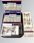 A tray of boxed stainless steel and plated flatware
