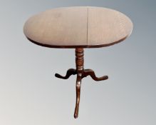 A 19th century oak tilt topped pedestal occasional table