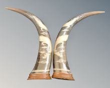 A pair of water buffalo horns decorated with dragons