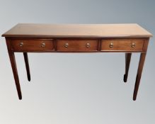 A reproduction mahogany Regency style three drawer hall table