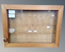 A pine framed wall mounted key cabinet
