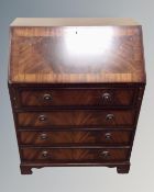 A Reproduction mahogany Regency style bureau fitted with four drawers
