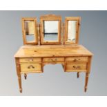 A Jaycee pine five drawer kneehole dressing table with triple mirror