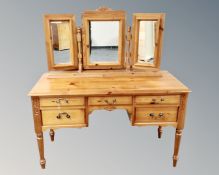A Jaycee pine five drawer kneehole dressing table with triple mirror
