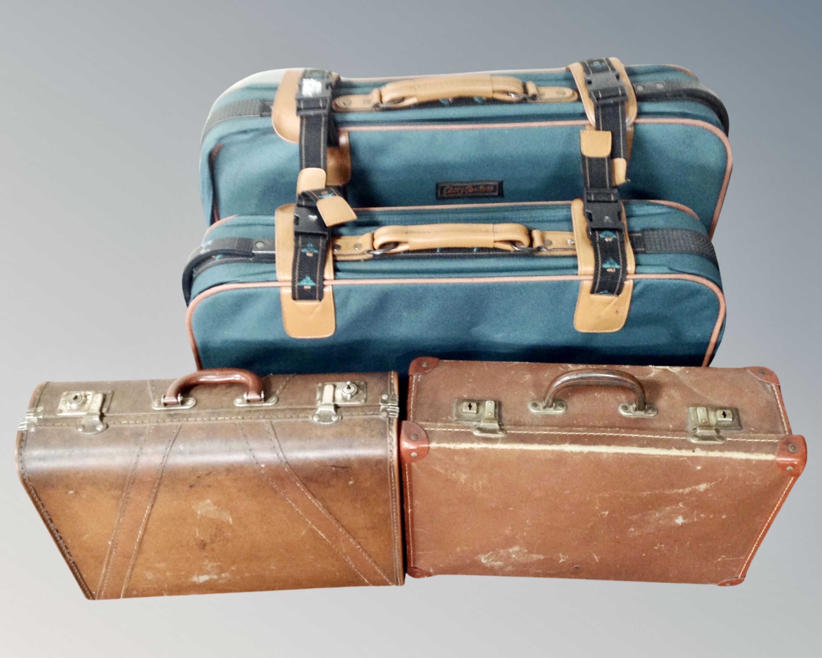 Two vintage luggage cases together with two further graduated fabric cases