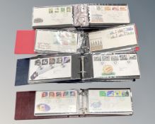 Stamps: A box containing four albums and a quantity of loose first day covers,