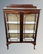 An Edwardian mahogany double door bookcase with astragal glazed doors