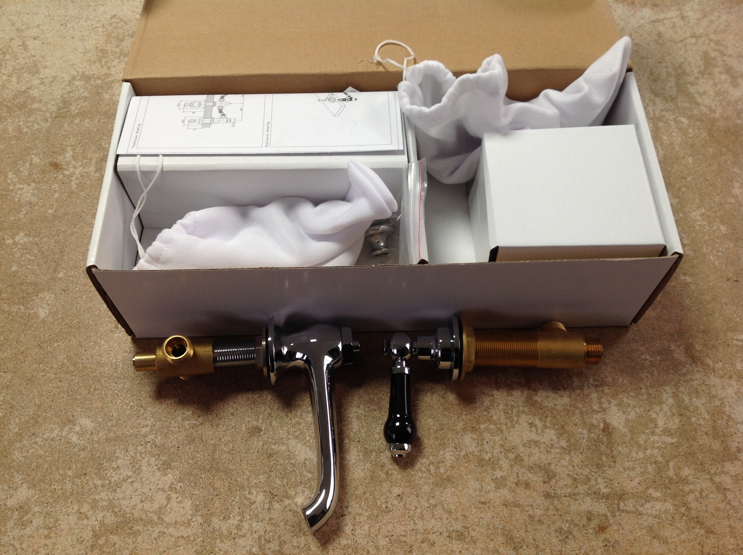 A traditional 3TH black lever basin mixer tap and pop-up waste, boxed.