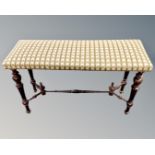 A rectangular window seat in studded tapestry upholstery with turned beech understretcher (length