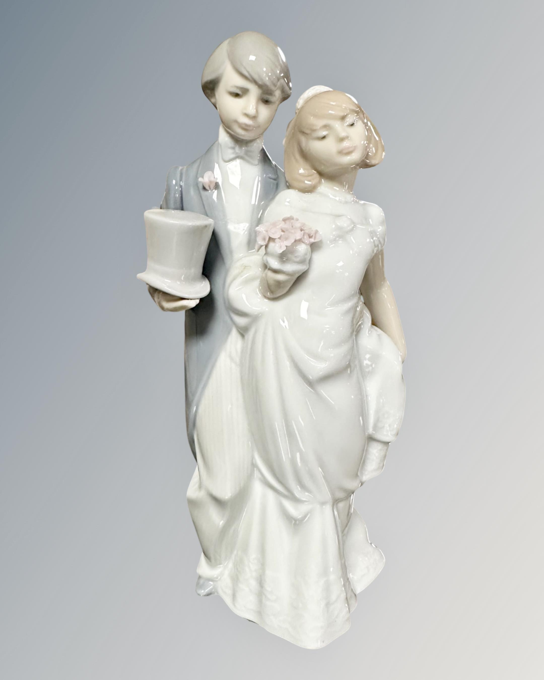 A Lladro figure of a bride and groom,